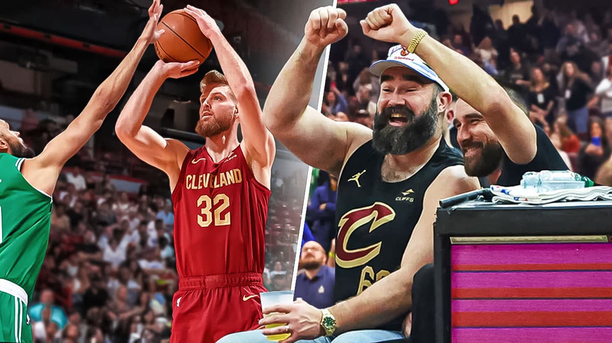 Cavs guard Dean Wade shooting against the Celtics with the Kelce brothers, Jason and Travis Kelce watching and smiling with popcorn in their hands at Rocket Mortgage FieldHouse in Cleveland